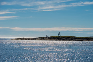 Navigation signs in the White Sea on an island on a summer afternoon