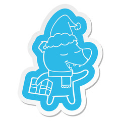 cartoon  sticker of a bear with present wearing santa hat