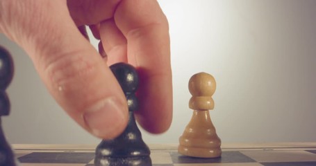 Special tracking macro shot moving between chess pieces on a chess board