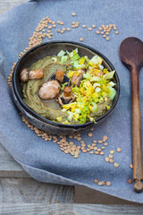 Mushroom puree, fried mushrooms and green cabbage and celery salad in handmade ceramic bowl.