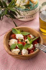 tomato salad with cheese and herbs on textile napkin