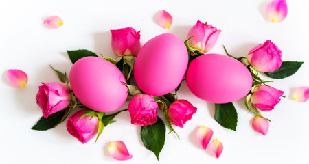 Pink Easter eggs on light background with  pink roses. Long wide banner with copy space.
