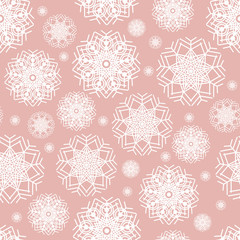 Seamless pattern of snowflakes  on a light pink background