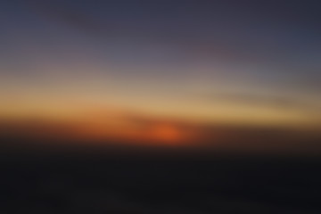 blurred abstract sunset in the clouds background