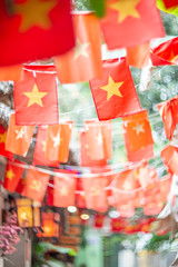 Fototapeta na wymiar Blurred background of Vietnamese flags on the street.