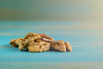 Fototapeta na wymiar Walnut kernels on a blue wooden background.