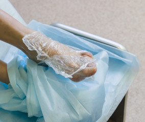 Pedicure. Process of wrapping of legs cellophane for softening of rough skin