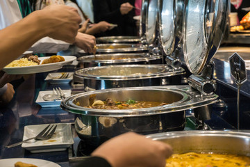 Close up hand of people take buffet food lunch meal