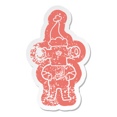 friendly cartoon distressed sticker of a alien wearing santa hat