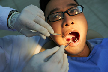 Man having dental check-up in clinic