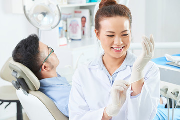 Female dentist preparing for work