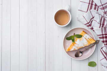 Cottage cheese casserole on a plate with powdered sugar and mint leaves. Selective focus Copy space