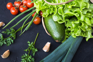 Fresh vegetables: cabbage, avocado, tomato, rosemary, garlic, mushrooms, leeks