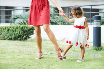 Adult lady and little lady outdoors
