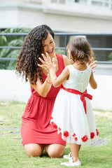 Woman and little girl playing outdoors
