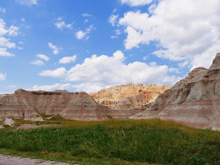 Wide view of the land formations and green prairie at Badlands National Park, South Dakota