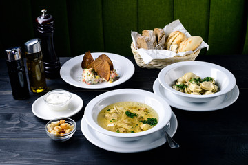 three-course set on the table in the restaurant, cafe menu, soup, second and salad