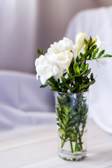 white freesia flowers in a glass