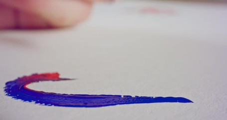 Macro shot of brush painting on paper with acrylic colors