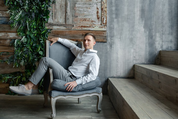 young man sitting on a bench in the park