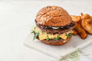 Tasty burger on light table