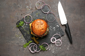 Tasty burger on grunge background