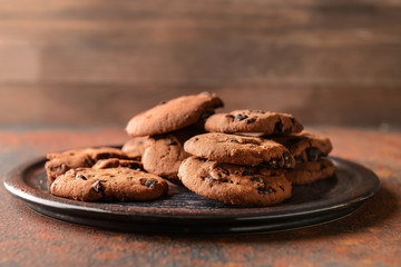 Tasty cookies with chocolate chips on plate