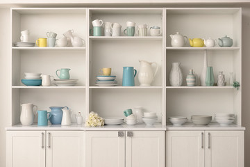 Cupboard with clean dishes in kitchen