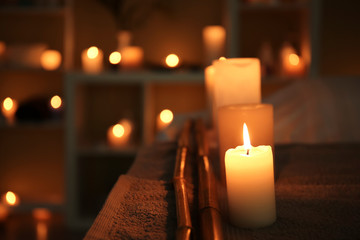 Burning candles on table in spa salon