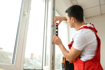 Fototapeta na wymiar Young worker installing window in flat
