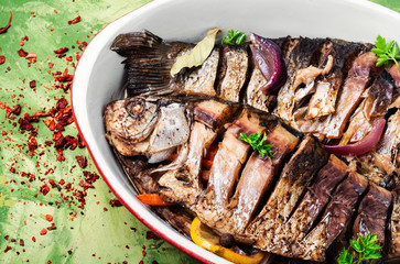 Two grilled fish in baking dish