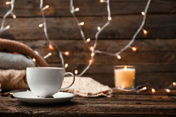 Cup of hot tea on wooden table