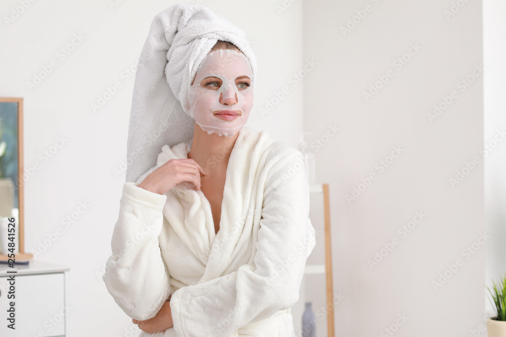 Sticker Beautiful young woman with sheet facial mask at home