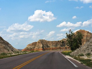 Paved winding road looping around the Badlands National Park in South Dakota, USA.