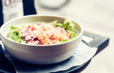 Smoked salmon salad with red onion in restaurant in Syracuse, Sicily, Italy.