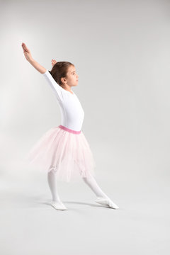 Cute little ballerina on light background