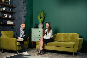couple sitting on sofa and watching tv