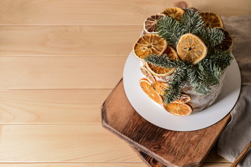 Sweet Christmas cake on wooden table