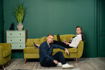 couple sitting on sofa and watching tv