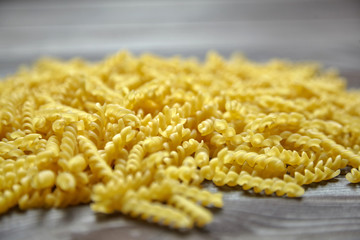 Italian spiral pasta on brown wooden table