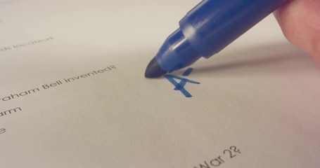 Macro shot of teacher marking a score on a school test