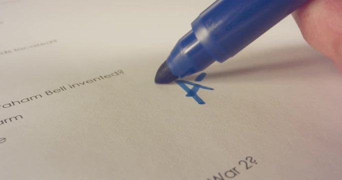 Macro shot of teacher marking a score on a school test