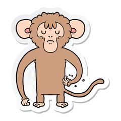 sticker of a cartoon monkey scratching
