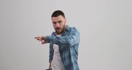 Carefree young man dancing over white background