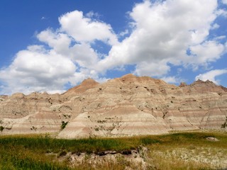 Closer view of the dramatic rock formatoins at Badlands National Park in South Dakota, USA, with gorgeous clouds in the skies.