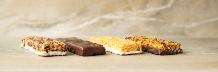 Various muesli bars on marble stone background