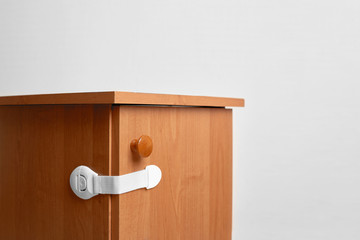 Bedside table wooden with baby proofing cabinet lock at home child safety