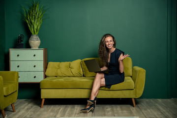 young woman sitting on sofa at home