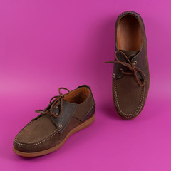 Men's brown moccasins, loafers isolated  on pink background. Side view, top view