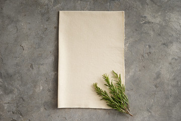 Fabric with fresh rosemary on grey table